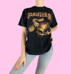 a woman wearing a black panther t - shirt with an image of a snake on it