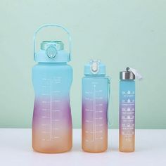 two water bottles, one blue and one pink with thermos on it sitting next to each other