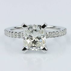 a cushion cut diamond ring with pave set shoulders