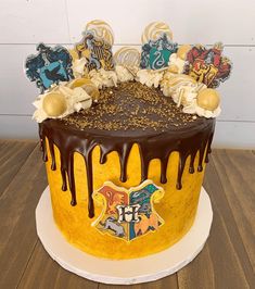 a harry potter cake with chocolate icing and hogwarts crest decorations on top