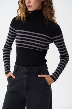 A turtleneck sweater with a milky stripe, combining a classic design with a subtle touch of elegance. The soft, ribbed fabric offers a comfortable fit and keeps you warm, while the milky stripe adds a refined, modern detail. The turtleneck provides extra warmth and a sophisticated look, making it ideal for layering during cooler months. This versatile piece can be effortlessly styled with both casual and formal outfits, adding a chic accent to your wardrobe. Black Turtleneck Sweater, Short Tank Top, Formal Outfits, Black Turtleneck, Jean Top, Formal Outfit, Blazer Dress, Ribbed Fabric, Long Sweaters