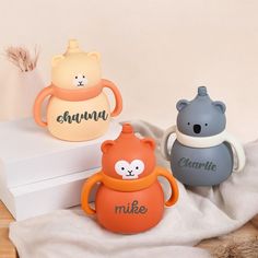 three small ceramic animals sitting on top of a white box with the word chum