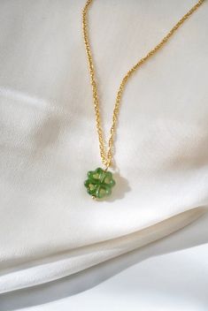 Jade Gemstone Necklace, Dainty Gold Filled Necklace Luck around your neck! With green jade and a lucky four leaf clover design, this necklace features a double dose of good fortune! Jade is believed to bring good luck, and the shamrock has been a Celtic symbol of fortune for centuries! DETAILS: - Natural green nephrite jade gemstone pendant - Carved by hand - 14k gold filled chain, spring clasp closure - Gemstone pendant: 13mm - Choose your desired length *Gemstones are natural and may slightly Green Jewelry For Good Luck, May Birthstone, Green Gemstone Necklace For Good Luck, Green Necklaces With Clavicle Chain And Flower Pendant, Jade Jewelry Necklace, Shamrock Necklace, Four Leaf Clover Charm, Lucky Necklace, Celtic Symbol, Luck Necklace