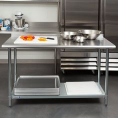 a kitchen with stainless steel counter tops and bowls on the top, next to a scale