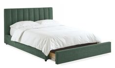 a bed with a green headboard and white sheets