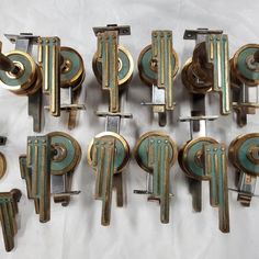 eight antique brass and green wall clocks on display