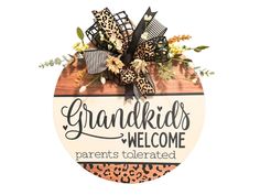 a wooden sign with the words grandkids welcome