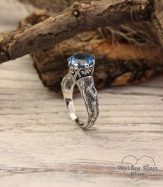 "A stunning vintage sterling silver engagement ring for the beautiful bride. An engraved branch with the texture of a real tree is adorned with twisted patterns and a large blue as clear sky topaz that plays with all its facets. A gift to make a special day magical. DETAILS: Stone - 9mm Natural Swiss Topaz Metal - recycled solid Sterling Silver Dimensions - width 9mm (0.35 in.), band width - 2mm (0.196 in.) Finish - oxidized (shiny at your request) View all silver branch rings:  https://etsy.me/3BrAI3m HOW TO ORDER ▪   Simply choose your ring size and a gemstone in dropdown menus. ▪   Add an engraving you'd like to have inside in the 'Personalization Box' (optionally). ▪   Feel free to contact me if you want to change anything about the ring design (dimensions, additional stones, material Branch Engagement Ring, Unusual Engagement Rings, Branch Ring, Silver Engagement Ring, Engagement Ring For Her, Real Tree, Wood Ring, Sterling Silver Engagement Rings, Local Jewelry