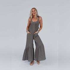 Elevate your boho wardrobe with this beautiful and versatile jumpsuit, the Bethany Wide Leg Ruffle Jumpsuit! It will keep you looking fabulous and feeling comfortable all day long because it features: Comfortable, lightweight, textured, cotton gauze fabric Relaxed and loose silhouette Flattering straight neckline with thick shoulders straps Convenient front patch pockets for your essentials Open back with cute adjustable, self - tie strap detail Gathered details along the wide legs and neckline for added style Effortless boho - chic outfit pair with: Kinsley Button Detail Seamless Brami, Nightbird Washed Lace Jacket, Sunburst Stacked Bralecet Set *Due to lighting and differences in monitors, actual colors may vary slightly from what appears online. Model is 5'8" and wearing a size Small. A Boho Wardrobe, Cotton Gauze Fabric, Ruffle Jumpsuit, Boho Chic Outfits, Lace Jacket, Ruffle Romper, Straight Neckline, Gauze Fabric, Chic Outfit