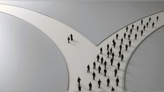 a group of people walking across a white bridge with an arch in the middle that connects two sides