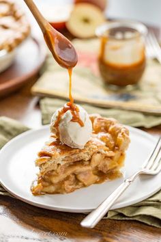 a slice of apple pie on a plate with ice cream being drizzled over it