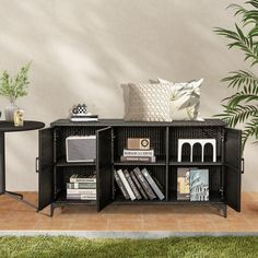 a book shelf with books, magazines and other items on it in front of a wall