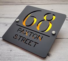 a metal sign with the number sixty8 on it that says paxton street