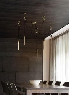 a dining room table and chairs in front of a window