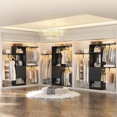 a large walk in closet with clothes and shoes on the shelves, chandelier