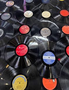 many different colored records are on display together