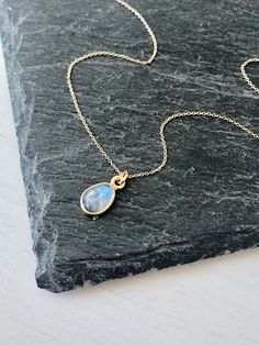 Rainbow Moonstone Necklace, Solid Gold Necklace, 14K Gold, June Birthstone, Small Moonstone Pendant, Anniversary Gift, Birthday gift for her Classic, Minimalist and Every Day Necklace featuring a small blue flash Rainbow Moonstone Pendant measuring 10 x 6 mm framed bezeled in solid 14k yellow gold. Pendant is suspended from a solid 14k gold cable chain. You can switch lengths at any time with 3 sizes to choose from: 16, 17 or 18 inches. All elements of this necklace are 100% SOLID Gold. They wil Gold Moonstone Necklaces For Anniversary, Gold Moonstone Necklace For Anniversary, Dainty Moonstone Necklace For Anniversary, Minimalist Moonstone Necklace For Anniversary, Moonstone Briolette Necklace For Gift, Moonstone Birthstone Necklace Gift, Oval Moonstone Necklace For Anniversary, Briolette Moonstone Necklace For Gift, Moonstone Necklaces With Natural Stones For Anniversary