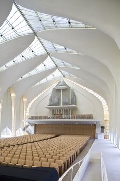 the inside of a church with rows of seats and a pipe organ in the background