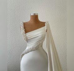 a white wedding dress on a mannequin