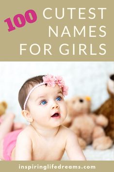 a baby girl with blue eyes and pink flowers in her hair is looking up at the camera