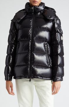 This hooded down puffer jacket crafted from glossy nylon is a contemporary take on an iconic Moncler design. A cockerel logo patch and engraved hardware bring signature touches to the look. Two-way front-zip closure Fixed hood Elastic cuffs Front zip pockets Lined, with down fill 100% polyamide Dry clean Imported Women's Designer Clothing Designer Quilted Hooded Puffer Jacket, Luxury Down Puffer Jacket With Detachable Hood, Designer Nylon Puffer Jacket With Padded Collar, Luxury Nylon Outerwear For Streetwear, Designer Down Puffer Jacket With Detachable Hood, Black Luxury Puffer Jacket With Double-lined Hood, Luxury Black Puffer Jacket With Double-lined Hood, Luxury Hooded Duck Down Puffer Jacket, Luxury Duck Down Puffer Jacket With Padded Collar