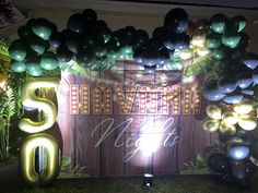 balloons and streamers decorate the entrance to a 50th birthday party