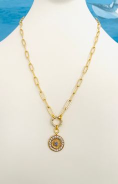 FAST FREE SHIPPING! Beautiful 18k Gold Filled Paperclip Chain Necklace with CZ Round Charm Holder that opens and has beautiful CZ stones on both sides. Stunning moonstone medallion. Necklace may be worn with or without charms of your choice. So versatile! Your choice of 15, 16, or 17 inches with 2 inch adjustable extender. Lobster clasp. Pave ring is 12mm. Stunning! Gold Gemstone Round Chain Necklace, Gold Gemstone Chain Necklace, Gold Chain Necklace With Round Gemstone, Gold Circular Jewelry With Adjustable Chain, Yellow Gold Jewelry With Cubic Zirconia Paperclip Chain, Gold-tone Circle Gold-plated Jewelry, Gold-tone Jewelry With Adjustable Round Chain, Gold-tone Circular Gold-plated Jewelry, Gold-tone Round Cubic Zirconia Jewelry