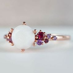 Beautiful handmade item! Here, on Etsy made as simulation only-just resin and white color.  Breastmilk Ring made with white gold plated sterling silver or plated with rose or yellow gold. Opal effect breastmik 7mm diamond shaped stone. Any size available. Rose gold,  or white gold plated options.  Pearl powder or opal effect can be added to this fine breastmilk ring.  Symbolic of the little diamond you brought into this world, our breastmilk stone ring shines bright. Beautiful inlaid cubic zirconia surround and accentuate your breastmilk stone while a skin-friendly 925 sterling silver ring core.  To see our full breastmilk Ring collection, please click here: https://www.etsy.com/ca/shop/KeepsakeMom?ref=simple-shop-header-name&listing_id=1095328032&section_id=24695275 To see All our items, White Dainty Opal Gemstone Ring, White Dainty Opal Ring, White Oval Ruby Ring, Oval White Ruby Ring, White Opal Birthstone Ring In Dainty Style, White Opal Birthstone Ring In 14k Gold, 14k Gold White Opal Birthstone Ring, White Opal Birthstone Promise Ring, Dainty White Opal Birthstone Ring