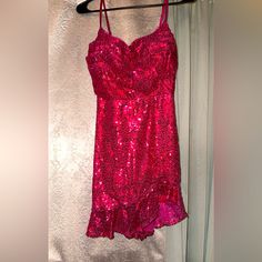 a pink dress hanging on a hanger