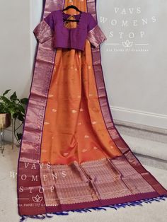 Orange Color Pure Kanchi Pattu Soft Silk Saree with stitched blouse Elevate your traditional wardrobe with this exclusive handpicked saree from Vavs Women's Stop. The beautiful combination of orange and purple in this handwoven Kancheepuram silk saree is a trendsetter in itself. The saree comes with a well-made, perfectly fitting stitched blouse, making it a hassle-free choice for any occasion. Our quick shipping from Prosper, Texas ensures that you receive your saree in time for all your auspic Orange Choli For Diwali And Traditional Ceremonies, Orange Handloom Pre-draped Saree, Orange Choli With Zari Weaving Traditional Drape, Orange Paithani Silk Blouse With Traditional Drape, Anarkali Choli With Zari Weaving In Orange, Anarkali Choli In Orange With Zari Weaving, Anarkali Style Orange Choli With Zari Weaving, Orange Zari Weaving Choli With Traditional Drape, Orange Anarkali Sets With Zari Weaving