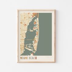 the miami beach map is mounted on a wall above a wooden framed art piece,