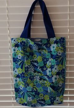 This large tote can carry all the important things you need to take along. It is interlined with a light interfacing, so it easily folds up to take on a shopping trip. Outer fabric - blue/green tropical floral Lining fabric - solid light blue Height - 17 inches Width - 12 inches Depth - 4 inches Pocket depth - 6 inches Hangs 9.5 inches from center of strap to top of bag. Tote Bag With Pockets, Small Crosses, Large Tote Bag, Tropical Floral, Folded Up, Mothers Love, Large Tote, Lining Fabric, Cute Bag