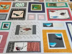 a quilt made with squares and birds on it's sides, all in different colors