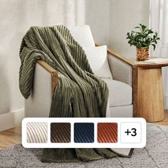 a couch with a blanket on it next to a potted plant