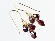 Garnet earrings Gold filled earrings deep red gemstone | Etsy Garnet Drop Jewelry For Gift, Gift Garnet Drop Jewelry, Gemstone Dangle Cluster Earrings As Gift, Burgundy Teardrop Jewelry For Gifts, Red Briolette Earrings For Anniversary, Burgundy Jewelry Set With Matching Earrings As Gift, Elegant Red Jewelry For Birthday, Red Dangle Earrings For Birthday, Red Gemstone Cluster Earrings For Gift