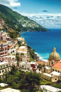 an aerial view of the ocean and buildings in positanoa, amalfna