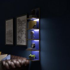 a living room with blue walls and leather chair in the corner, along with pictures on the wall