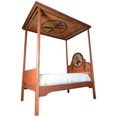 an old fashioned bed with a wooden frame and clock on the top, against a white background