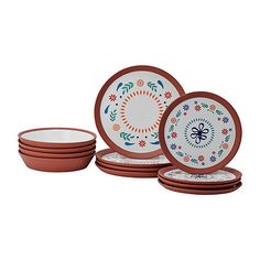 a set of four dinner plates with different designs on the front and side, in various colors