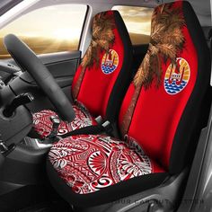 the interior of a car with red and black seat covers, palm trees on it