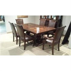 a dining room table and chairs with brown leather upholstered on the backrests