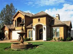 a house with a fountain in the front yard