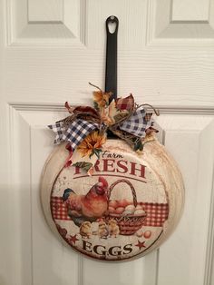 a sign hanging on the front door of a house that says fresh eggs and an egg basket