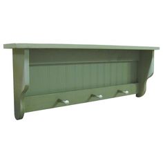 a green shelf with three hooks on it