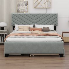 a large bed sitting on top of a hard wood floor next to a white wall