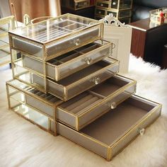 a stack of jewelry boxes sitting on top of a white furnishing covered floor