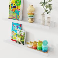 two white shelves with books and toys on them