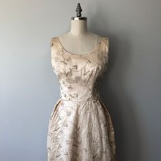 1950s Style Sleeveless Wedding Dress, 1950s Sleeveless Wedding Dress, Cream Sleeveless Vintage Dress For Wedding, Vintage Sleeveless Wedding Dress, Cream Sleeveless Vintage Wedding Dress, Vintage Floral Embroidery Evening Dress, Fitted Tea-length Dress With Floral Embroidery, Sleeveless Vintage Dress With Fitted Bodice For Wedding, Fitted Floral Embroidered Tea Length Dress