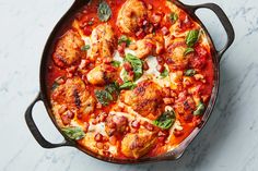 a skillet filled with chicken and tomato sauce