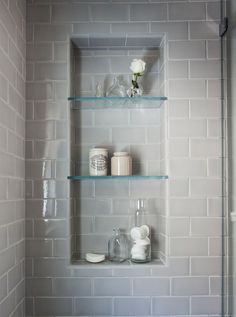 a bathroom with two shelves on the wall